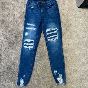 Jeans with holes and cut at bottom